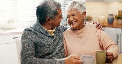 Buy stock photo Hug, laughing and senior couple with coffee, home and bonding with beverage in kitchen, people and morning. Happy, old man and mature woman with tea in house, comfortable and conversation for family