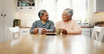 Buy stock photo Kitchen, morning and old couple with coffee for laughing, bonding and biscuits for breakfast in retirement. Senior people, woman and man with smile for love, funny joke and cookies with tea at home
