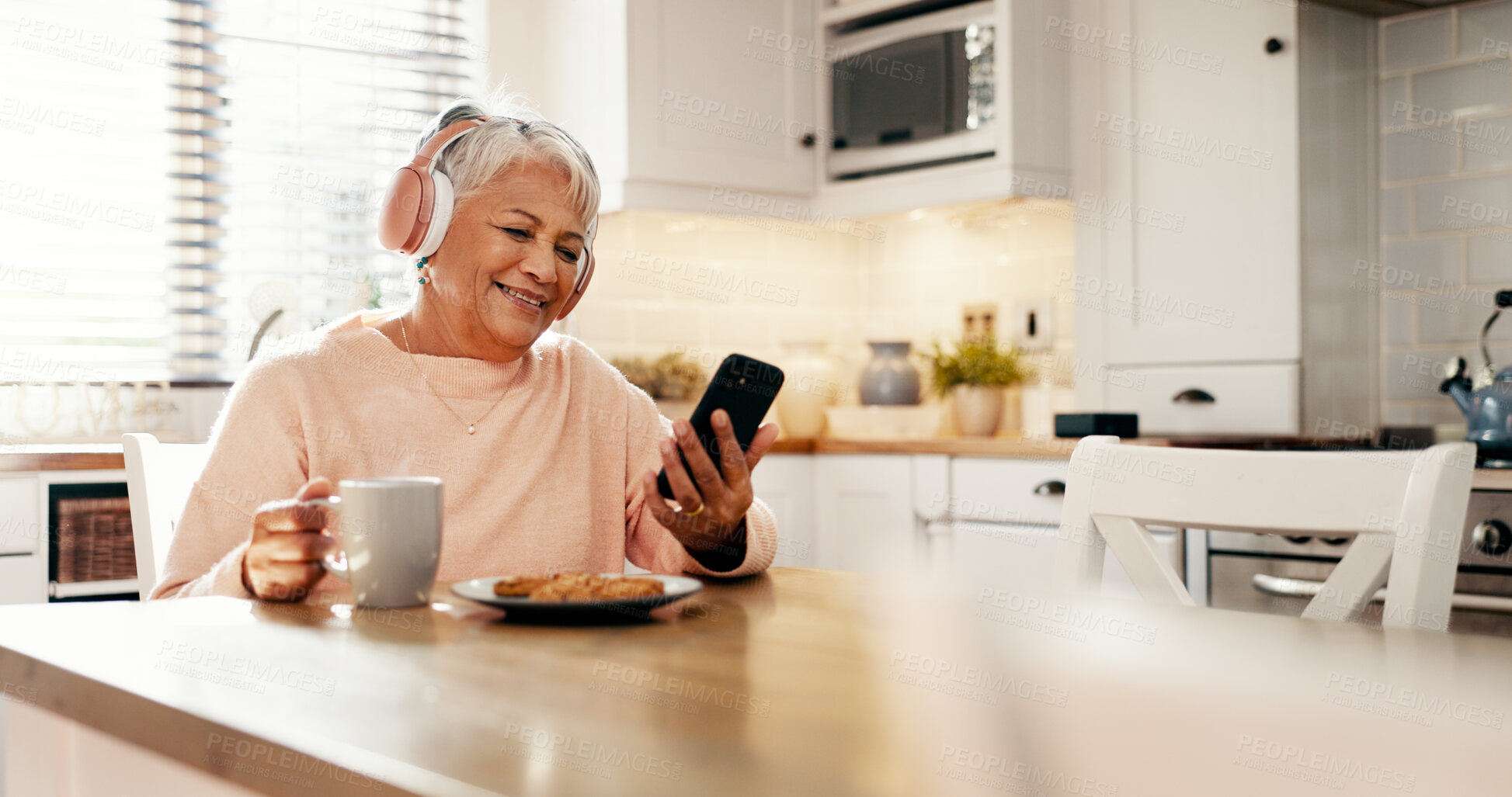 Buy stock photo Coffee, music and senior woman with phone in home for streaming subscription, app and entertainment. Headphones, eating and mature person with food, smile or mobile for retirement, radio and podcast
