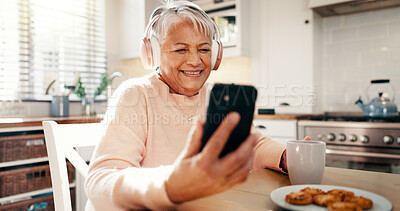 Buy stock photo Breakfast, headphones and senior woman with phone in home for streaming subscription or entertainment. Music, podcast and mature person with coffee, smile or mobile for retirement, radio and wellness