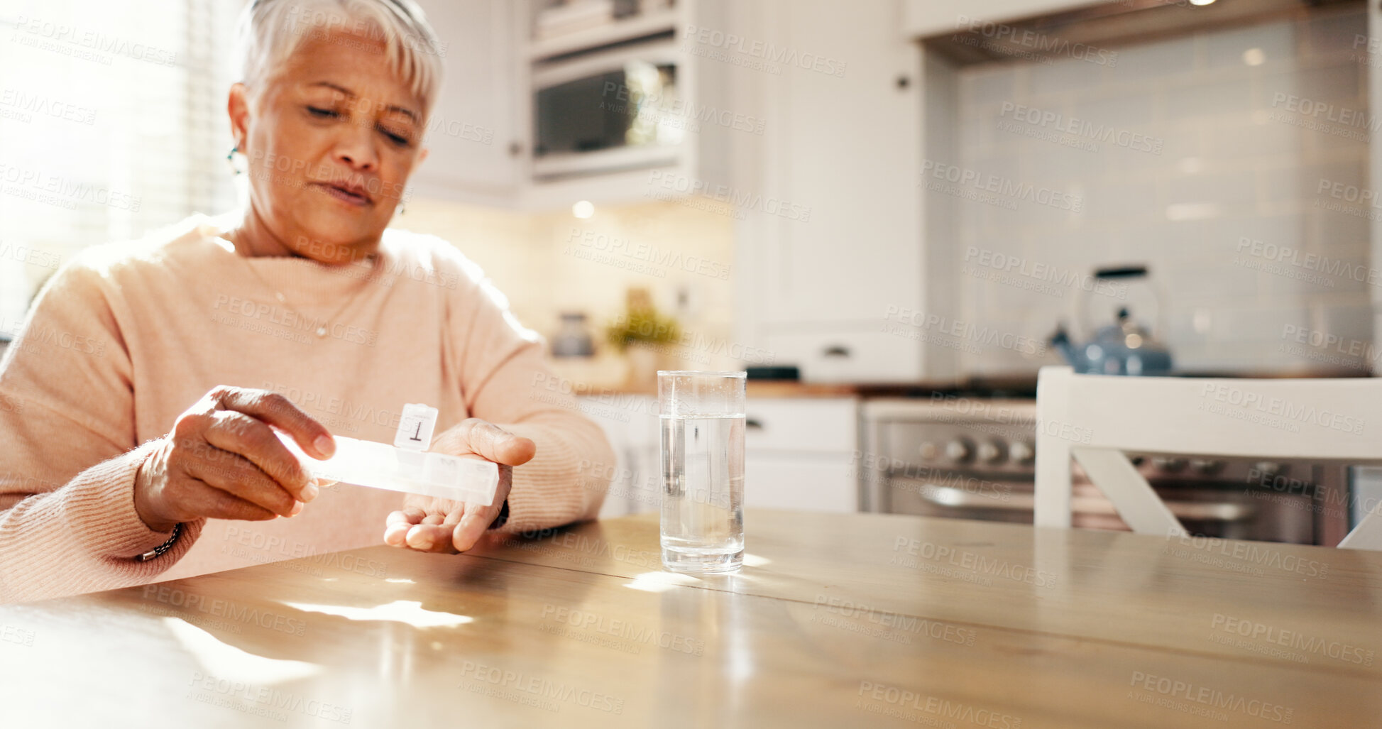Buy stock photo Senior, woman and drinking pills in home for prescription medication, tablets dosage and health management. Elderly person, water and medicine organzier for supplements, daily routine and treatment