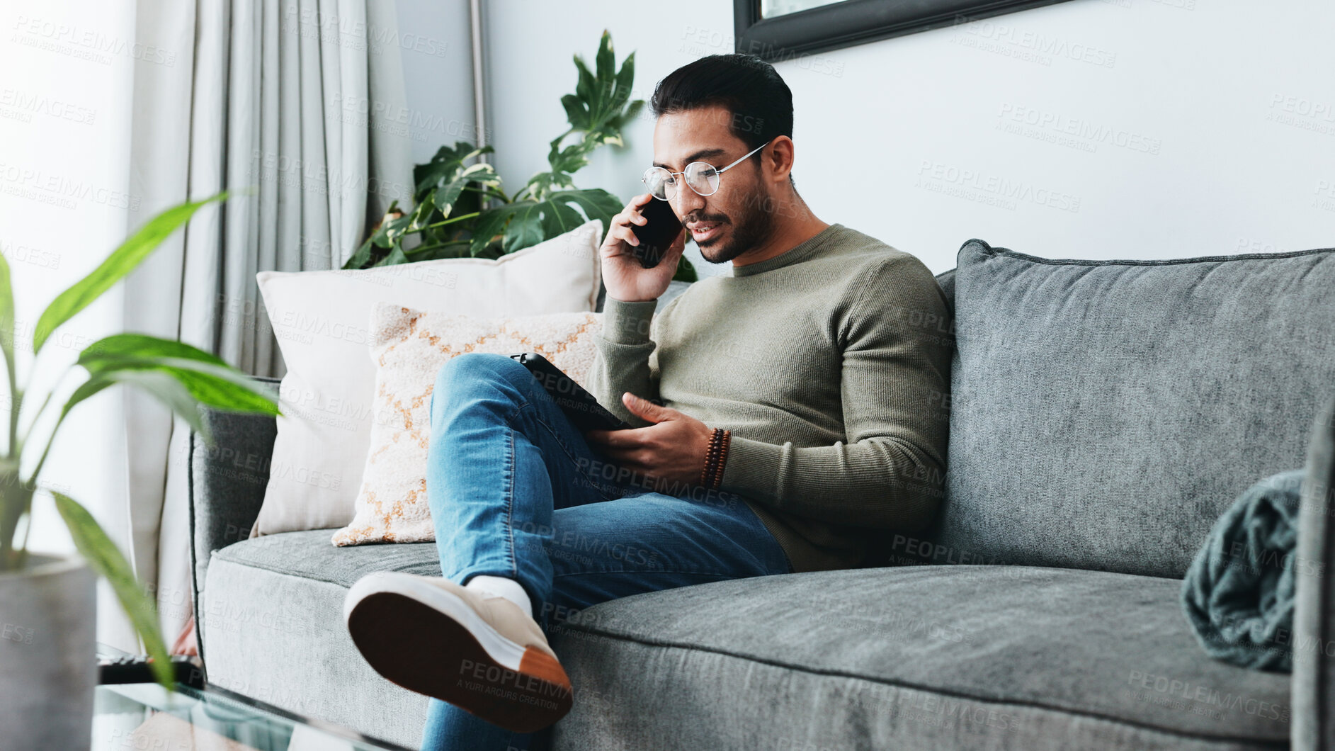 Buy stock photo Phone call, talking and man on sofa on tablet for communication, social networking and chatting. Living room, home and person on smartphone and tech for website, online conversation and connection