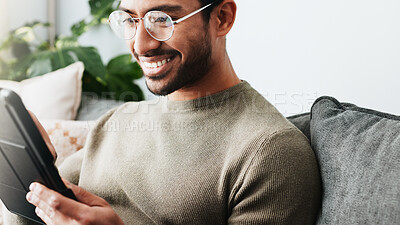 Buy stock photo Home, smile and man on couch, tablet and glasses with connection, weekend break and social media. Apartment, guy and happy person on sofa, tech and communication with digital app, eyewear and network