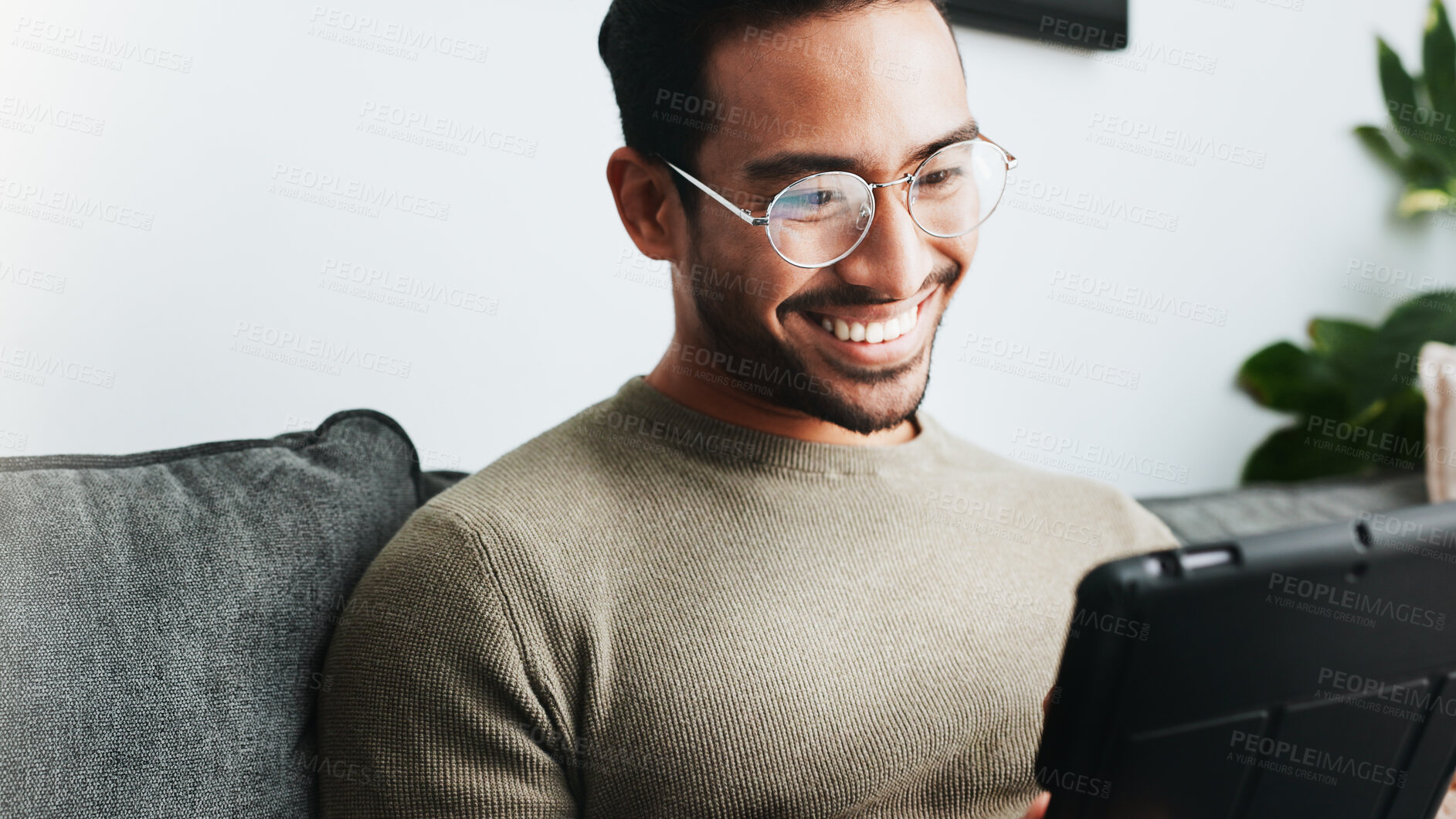 Buy stock photo Home, smile and man on sofa, tablet and glasses with connection, weekend break and entertainment. Apartment, guy and happy person on couch, tech and communication with digital app and social media