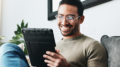 Buy stock photo Home, laugh and man on sofa, tablet and glasses with connection, online comedy video and entertainment. Funny, guy or happy person with tech, joke and communication with app, smile or social media