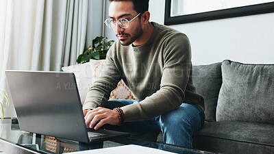 Buy stock photo Glasses, reading and laptop with man on sofa for freelancer, business research and email. Communication, typing and online with person in living room at home for remote worker, networking and blog