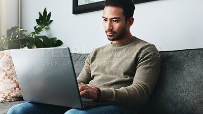 Buy stock photo Reading, online and laptop with man on sofa for freelancer, networking and email response. typing, communication and remote worker with person in living room of home for business proposal or research