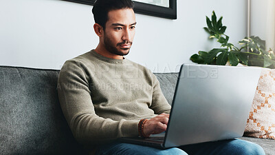 Buy stock photo Typing, relax and laptop with man on sofa for freelancer, networking and email response. Reading, communication and remote worker with person in living room of home for business proposal or research