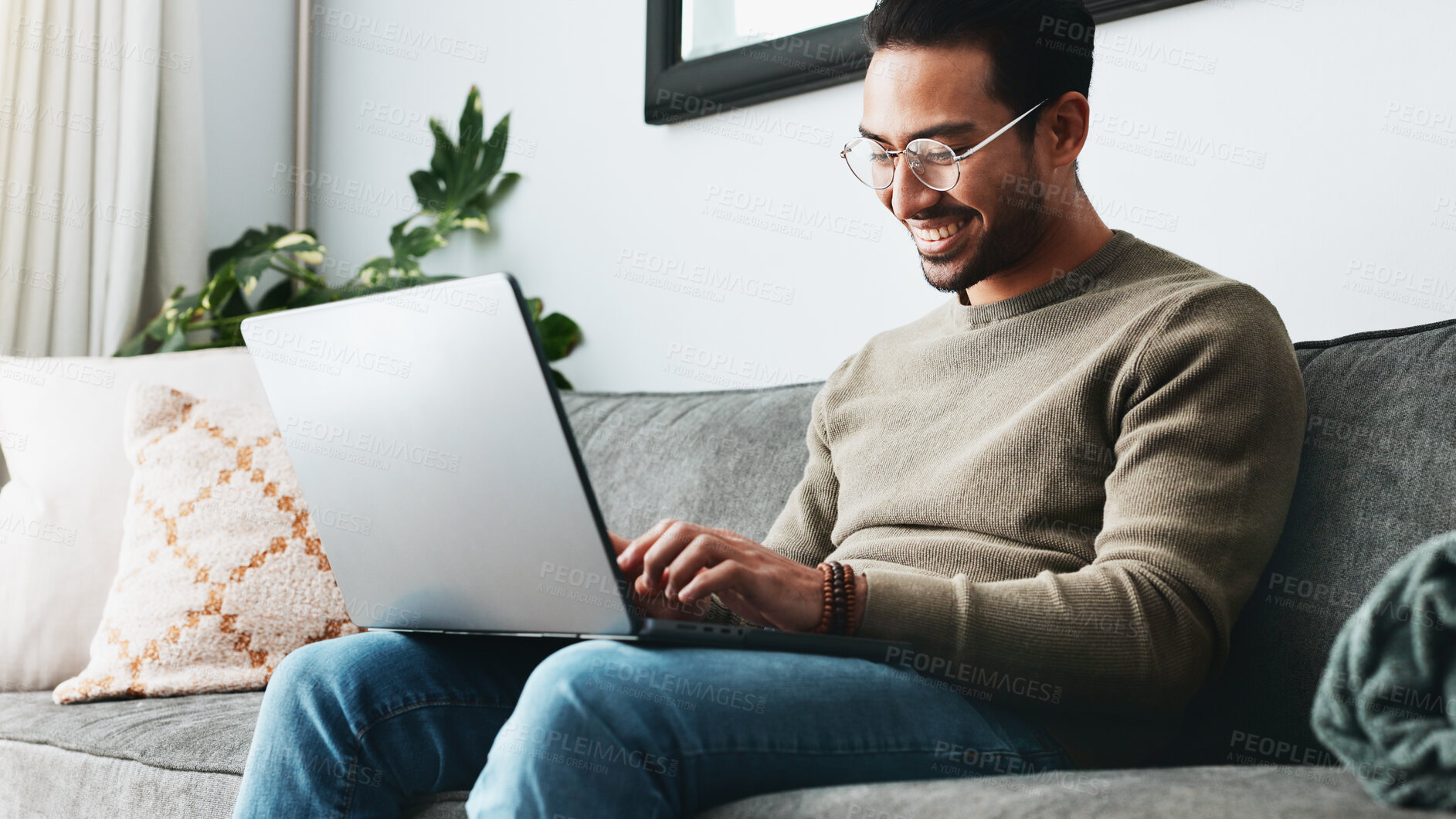 Buy stock photo Smile, online and laptop with man on sofa for freelancer, networking and email response. Reading, communication and remote worker with person in living room of home for business proposal or research