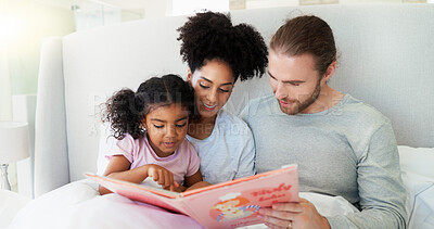 Buy stock photo Parents, girl and book in bed for story, happy and learning with care, bonding or language in home. Father, mother and daughter with reading, love and education with smile at interracial family house