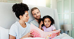 Parents, girl and story book in bed for reading, happy and learning with care, guide or language in home. Father, mother and daughter with relax, love or smile for bonding at interracial family house