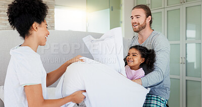 Buy stock photo Parents, pillow fight and girl in bed, happy and excited with care, game and love at apartment. People, father and mother with play, energy and bonding with connection at interracial family home