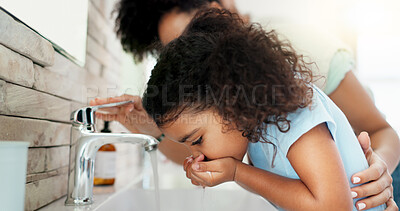 Buy stock photo Girl, mom and child cleaning mouth for hygiene, morning routine or teaching healthy oral habits in home. Parent, washing or kid learning dental care in bathroom with basin water, mother and support 