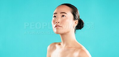 Buy stock photo Thinking, woman and natural beauty in studio with skincare treatment results, healthy glow and skin hydration. Mockup space, Asian girl and confidence with dermatology or self care on blue background