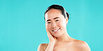 Happy, skincare and portrait of Asian woman in studio for wellness, cosmetics and facial treatment. Dermatology, mockup space and person for healthy skin, salon and beauty results on blue background