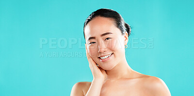 Buy stock photo Happy, skincare and portrait of Asian woman in studio for wellness, cosmetics and facial treatment. Dermatology, mockup space and person for healthy skin, salon and beauty results on blue background