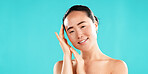 Beauty, skincare and portrait of Asian woman on blue background for wellness, cosmetics and facial treatment. Dermatology, mockup space and person for healthy skin, salon and spa benefits in studio