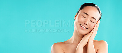 Buy stock photo Eyes closed, beauty and Asian woman with cosmetics, dermatology and shine on blue studio background. Person, mockup space and model with wellness, aesthetic and natural glow with healthy skin