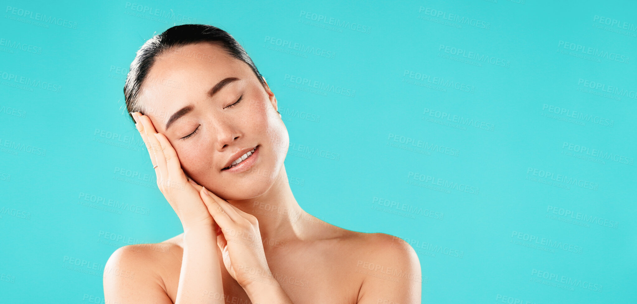 Buy stock photo Closed eyes, skincare and Asian woman with cosmetics, dermatology and beauty on blue studio background. Person, mockup space and model with texture, wellness and natural glow with healthy skin