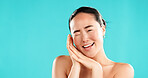 Beauty, wink and portrait of Asian woman in studio for wellness, cosmetics and facial treatment. Dermatology, mockup space and person with emoji for health, beauty and spa benefits on blue background