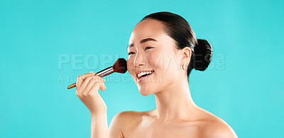 Buy stock photo Studio, asian woman and smile with brush for makeup, foundation and application of cosmetics. Mockup space, female person and happy model with tool for powder, beauty and wellness by blue background