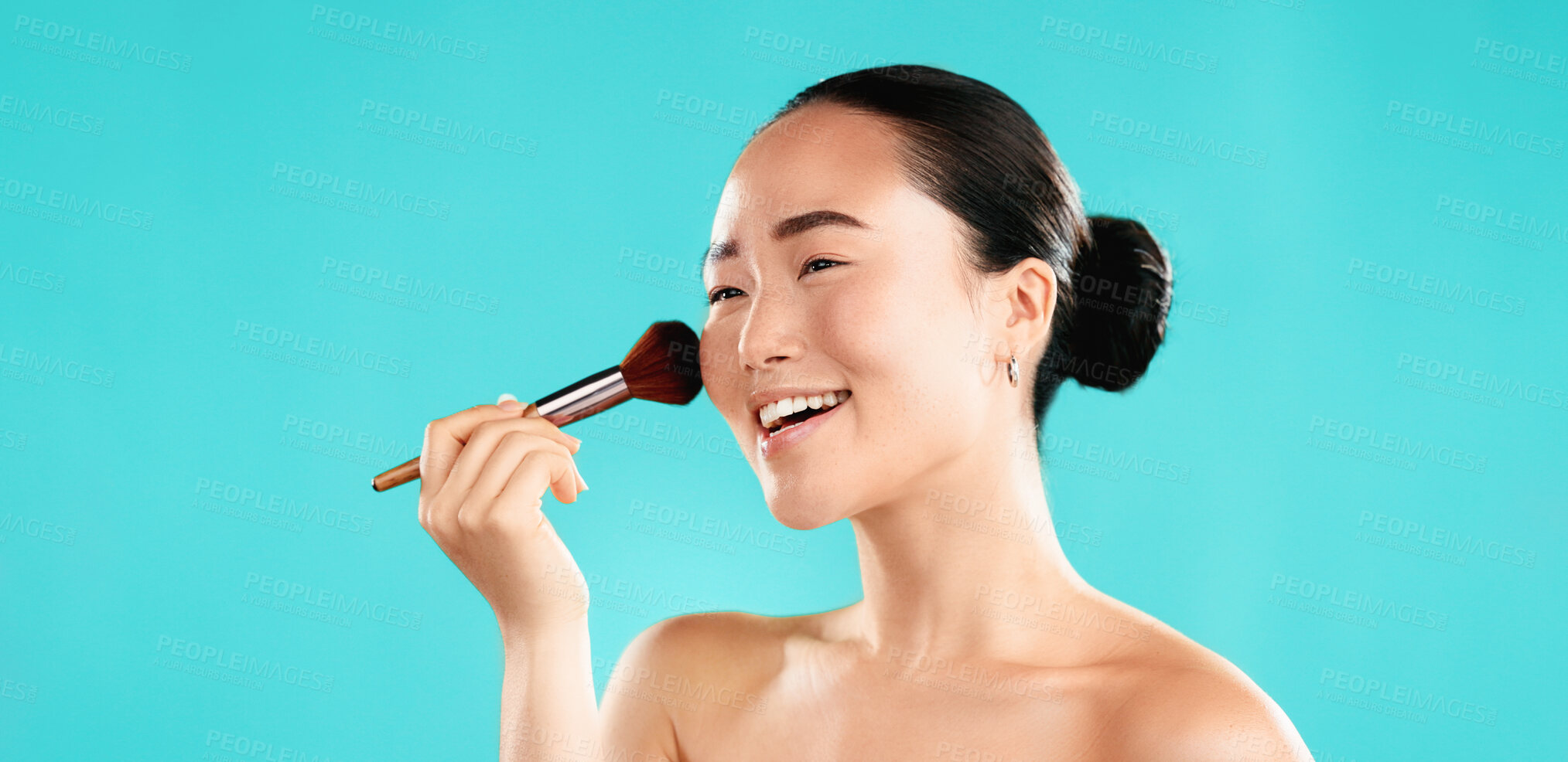 Buy stock photo Studio, asian woman and smile with brush for makeup, foundation and application of cosmetics. Mockup space, female person and happy model with tool for powder, beauty and wellness by blue background