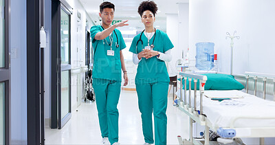 Buy stock photo Hospital, discussion and nurses in hallway talking for consulting, meeting and planning. Healthcare, collaboration and man and woman for medical service, conversation and help in clinic for support