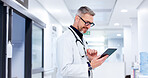 Mature, man or doctor on tablet for cardiology results, medical update or appointment booking online. Smile, research or cardiologist with touchscreen for report, schedule or health app at hospital