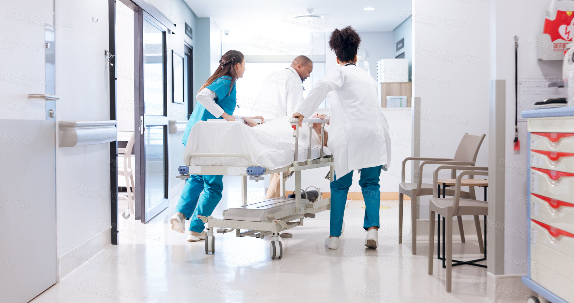 Buy stock photo Running, hospital and doctors with stretcher in hallway for emergency, surgery and help for medical service. Healthcare, icu and people rush with bed for accident, operation or surgical treatment