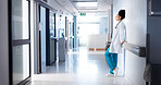 Doctor, woman and tired in hospital corridor for healthcare crisis, medical burnout or bad news. Health professional, stress and disappointed with clinic loss, medicine fail or overwhelmed in hallway