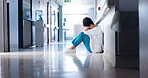Doctor, woman and stress on hospital floor for healthcare crisis, medical challenge and bad news. Professional, tired and grief with clinic loss, medicine fail or overwhelmed by burnout in corridor