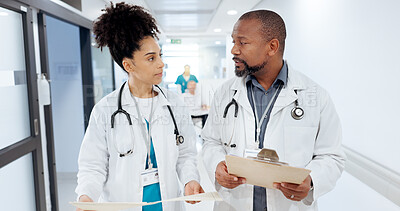 Buy stock photo Hospital, discussion and doctors in hallway with clipboard for consulting, patient results and planning. Healthcare, documents and man and woman for medical service, diagnosis and collaboration