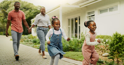 Buy stock photo Outdoor, black family and parents with children for running, playful and bonding together by house. Holding hands, mom and dad with kids for walking, happiness and relationship on weekend in property