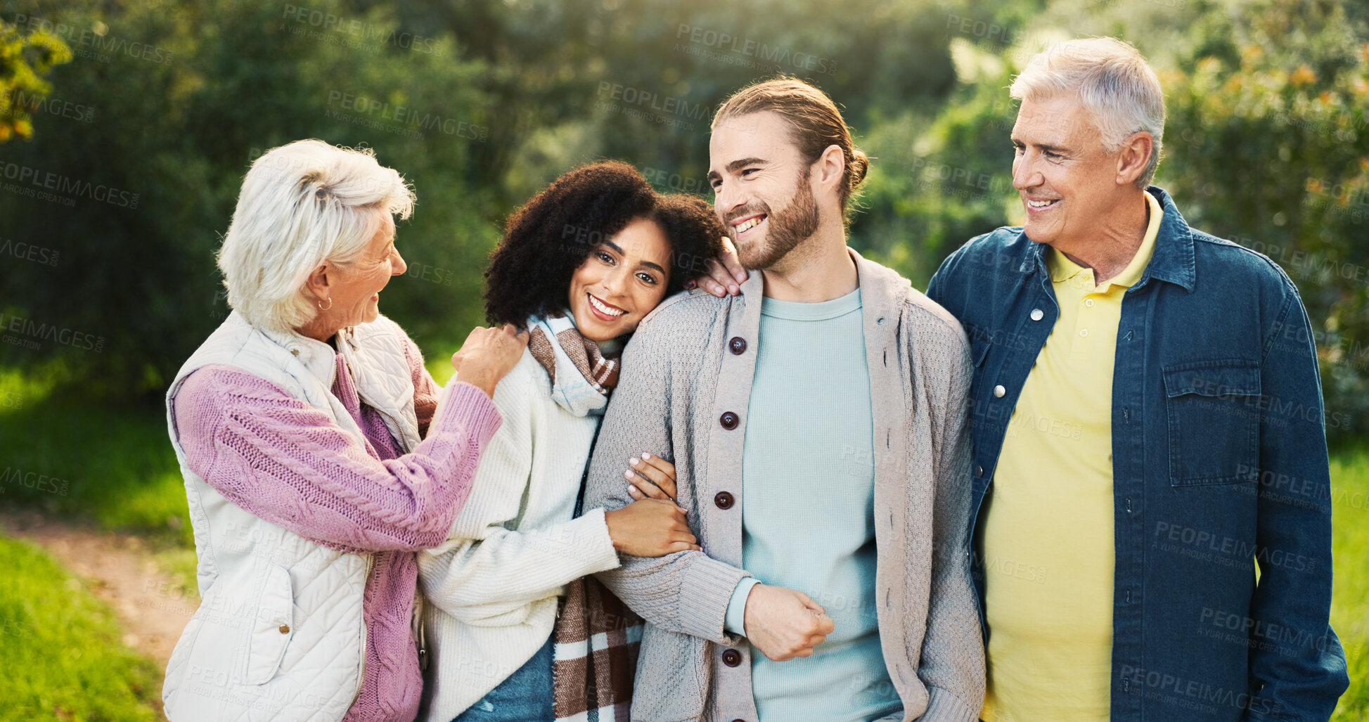 Buy stock photo Happy couple, hug or senior parents in park for bonding with love, interracial relationship or care in retirement. People, mature mother and father with family support in nature on holiday vacation