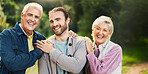 Happy, park and senior parents with son for bonding, relationship and relax together. Nature, family portrait and elderly dad, mom and man embrace outdoors for love, affection and care on weekend