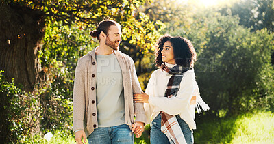 Buy stock photo Outdoor, holding hands and couple on walk, talking and people with smile on date, romance or break. Park, man and woman in relationship, bonding and happy for interracial marriage, travel or together