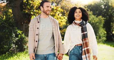 Buy stock photo Dating, holding hands and walking with couple in park together for anniversary, bonding or romance. Love, smile or vacation with interracial man and woman outdoor in nature for adventure or journey