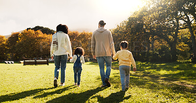 Buy stock photo Walking, back and bonding with family in park for holding hands, support and autumn season. Love, nature and adventure with parents and children outdoors for travel, care and vacation together