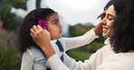 Flowers, love or smile with mother and daughter outdoor in nature for bonding, safety or trust. Family, happy or relationship with girl child and single parent woman in garden for earth day or spring