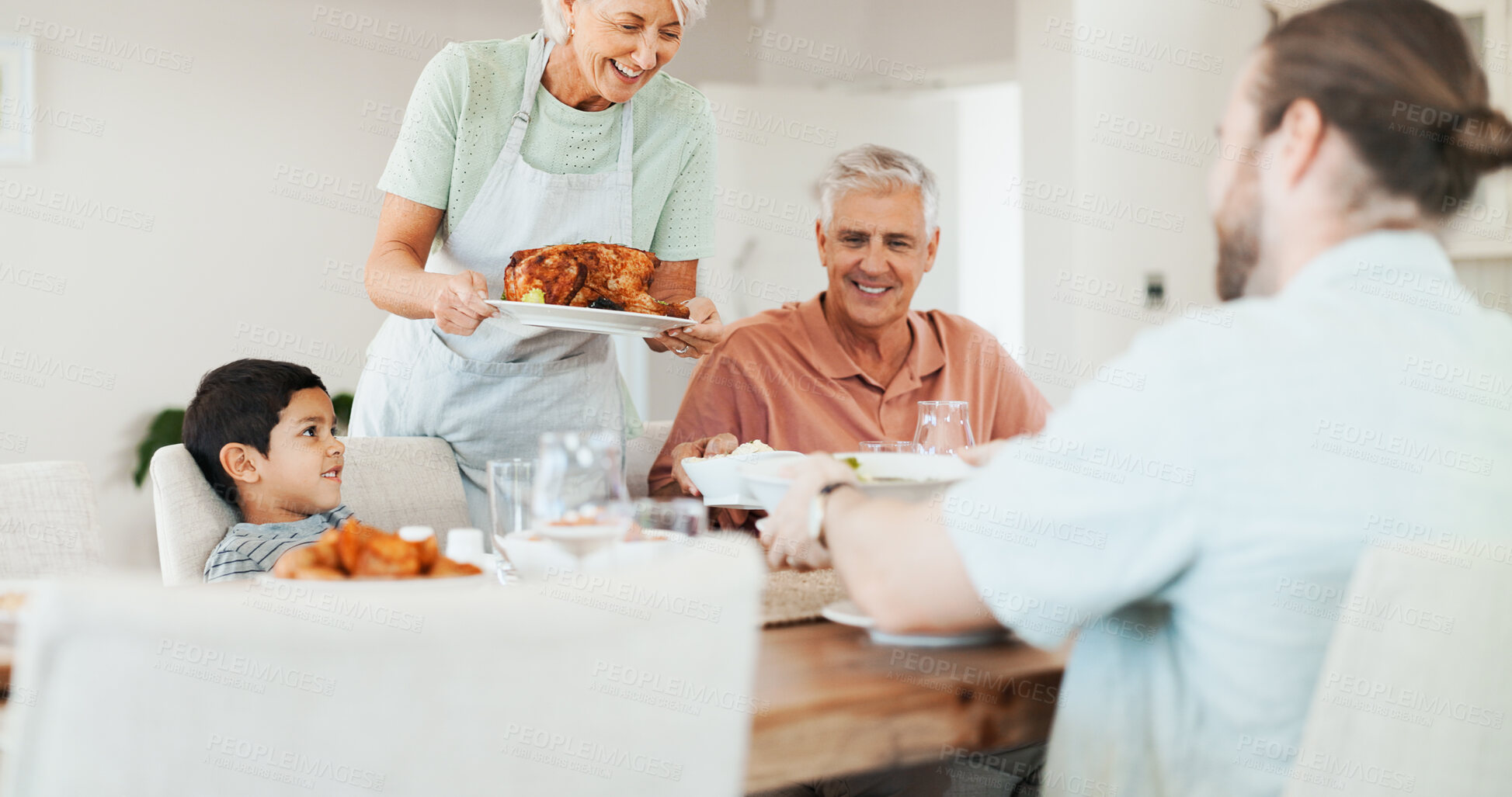 Buy stock photo Love, chicken and lunch with big family in dining room for bonding, food and nutrition. Support, happiness and grandparents with child and parents eating at home for relax,  serving and health