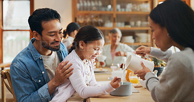 Buy stock photo Family, child and parents with serving breakfast for healthy meal, pouring milk or helping with porridge. Love, home or happy people in dining room for lunch, nutrition and relax with care or support
