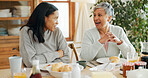 Breakfast, love and talking with family at home for bonding, nutrition and croissant food. Morning, wellness and health with women eating in dining room of house for connection, support or brunch