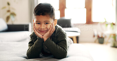 Buy stock photo Portrait, smile and child relax in lounge for peace, calm morning and weekend break. Happy, boy and kid on the couch for school holiday, comfortable and resting for growth of childhood at house