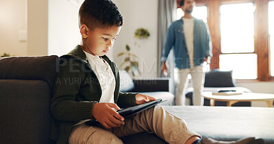Buy stock photo Relax, tablet and search with child on sofa for streaming service, movie subscription and online. Cartoon app, scroll and entertainment with boy and father in family home for weekend and show