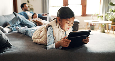 Buy stock photo Home, kid and girl with tablet for streaming, watch movies and online game with technology. Couch, parents and child with digital for video application, cartoon and ebook on website in living room