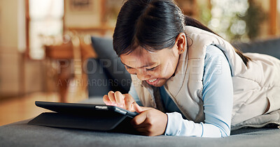 Buy stock photo Couch, child and girl with tablet for game, entertainment and online fun with technology at home. Sofa, relax and happy kid with digital for application, streaming or scroll on website in living room