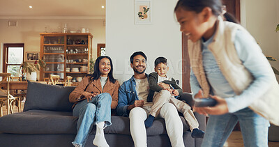 Buy stock photo Parents, girl and remote control in lounge, playful and happy on sofa for game, running or watching tv in house. Dad, mom and children with choice for movie, love or cartoon with laugh in family home