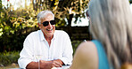 Happy, senior couple and laugh on date with romance, funny joke and partner love for retirement brunch. Smile, elderly people and talk with champagne, anniversary celebration and commitment of picnic