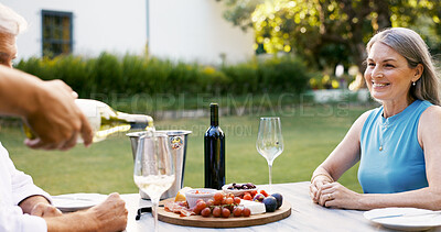 Buy stock photo Person, pour wine and couple on date for romance, anniversary celebration and breakfast picnic. Senior people, champagne or charcuterie board, bonding and relationship commitment in backyard at house