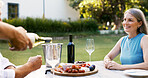 Hands, wine and senior woman on date with romance, anniversary celebration and breakfast picnic. Elderly couple, pour champagne and healthy food, bonding and marriage commitment in backyard at house